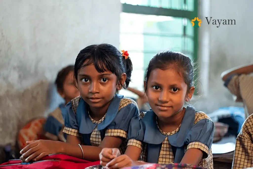 Two girls in school uniforms, representing the empowerment of girls through education and the work of verified NGOs helping save the girl child.