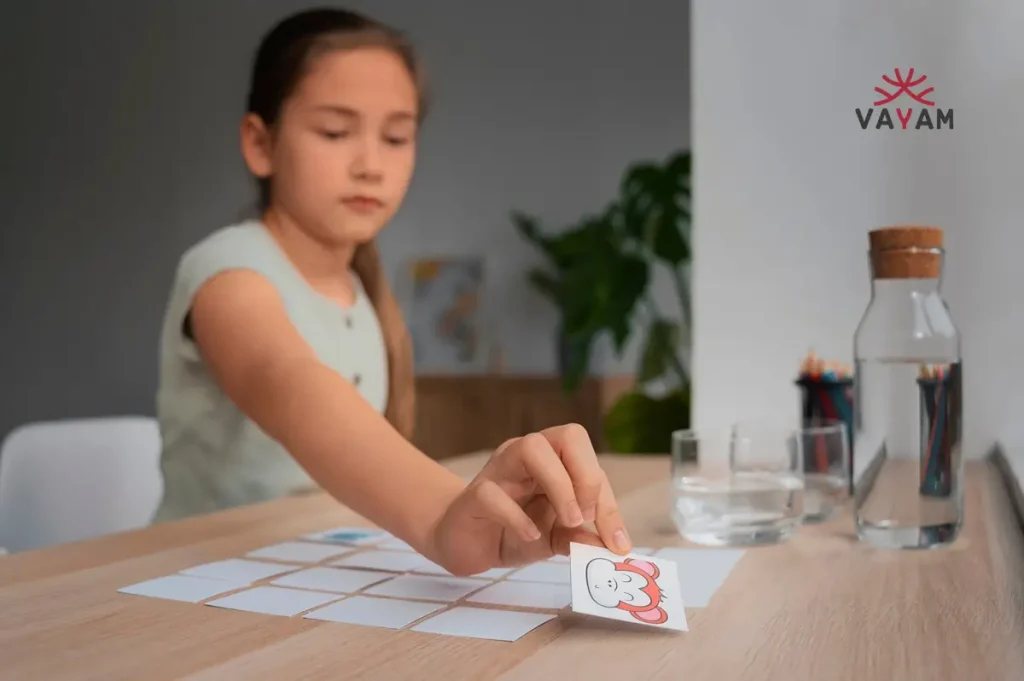 A girl engaged in a board game, showcasing emotional resilience while placing a sticker on the game board.