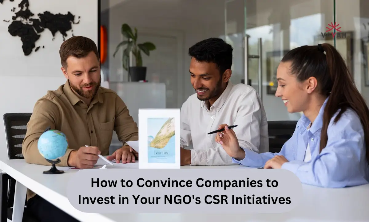 Three professionals seated at a table, with a globe in view, illustrating the importance of global perspectives in NGO CSR efforts.