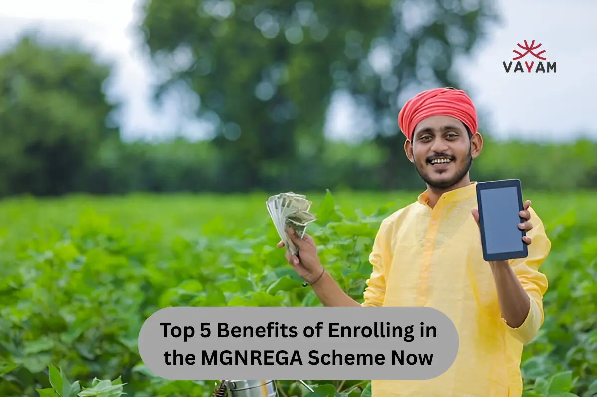 Indian farmer in a field with a digital tablet, researching the top benefits of the MGNREGA scheme for rural development