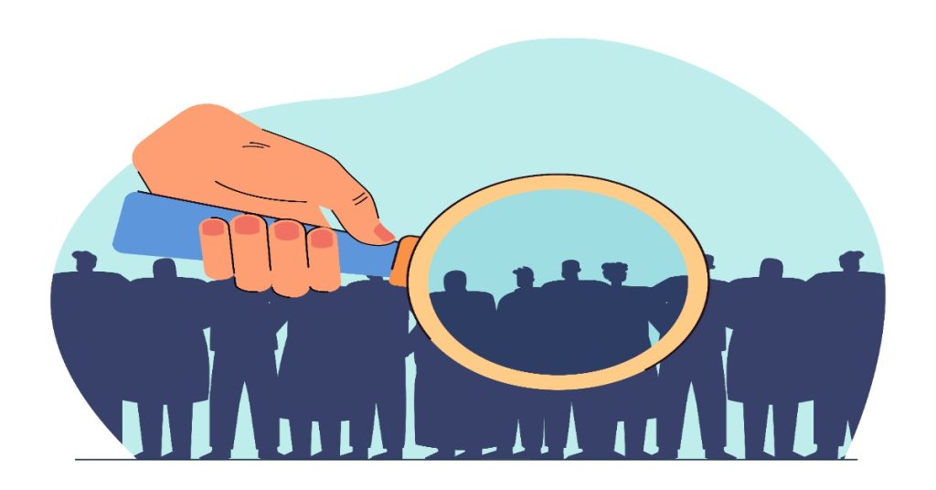 A hand using magnifying glass above a crowd, illustrating CSR teams identifying the right individuals.