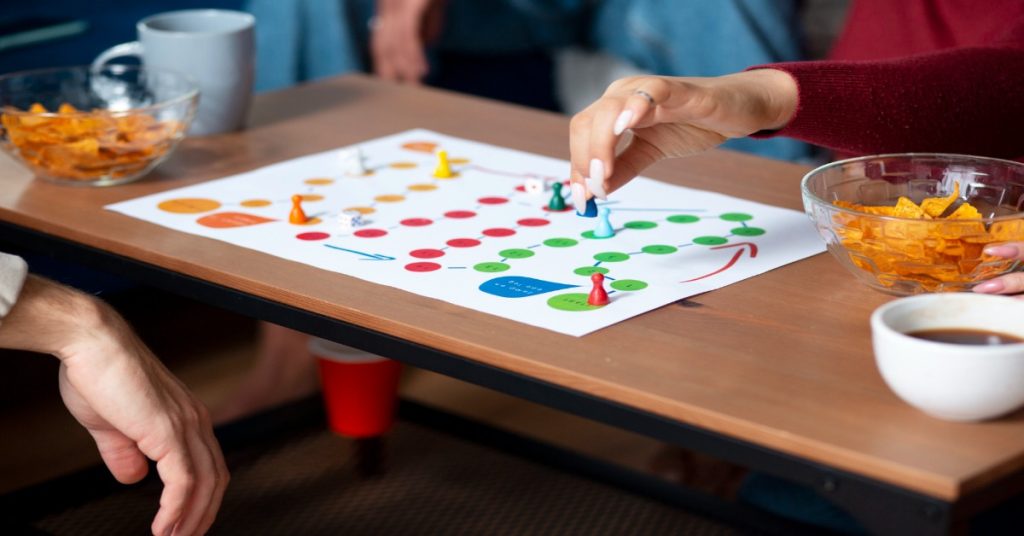 A person engaged in a board game with others, focusing on programs and problem-solving strategies.