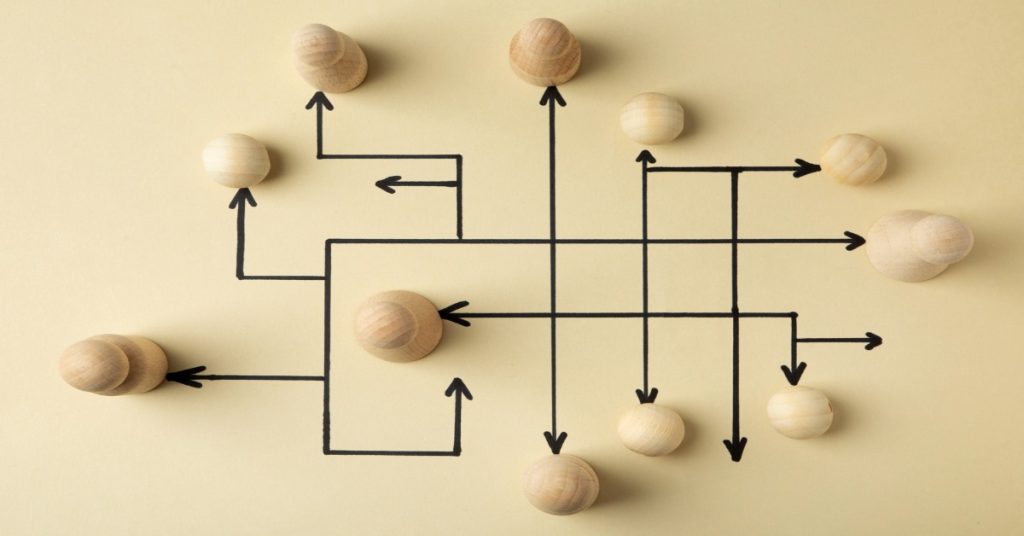 Wooden pawns on a wall, illustrating panchayats in the planning process, from village vision to reality.