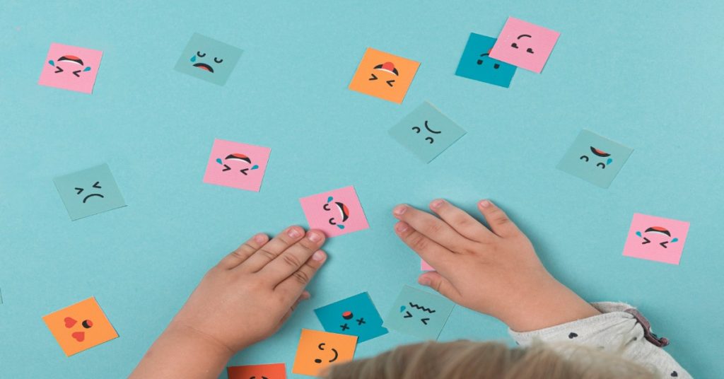 Different emotions are depicted through faces made on different sticky notes to denote emotional intelligence.