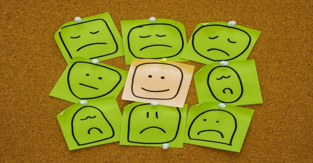 A joyful expression on a sticky note with other smiley faces, emphasizing the importance of emotions in learning.