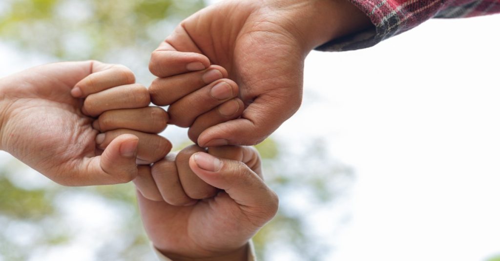 Children’s hands united, symbolizing donor support for holistic empowerment beyond education.