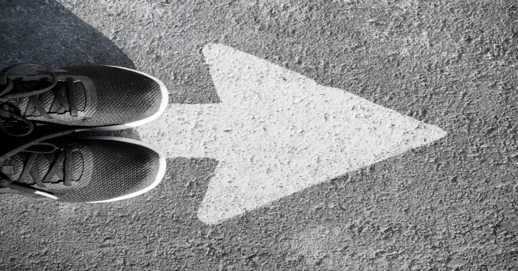 A pair of running shoes with an arrow, representing the reality of child labour and the call to move beyond awareness to action.