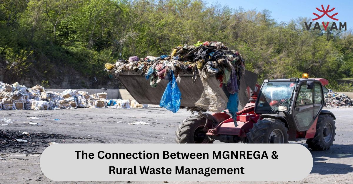 A wheel loader filled with the loader filled a huge pile of trash to illustrate the link between MGNREGA initiatives & rural waste management.